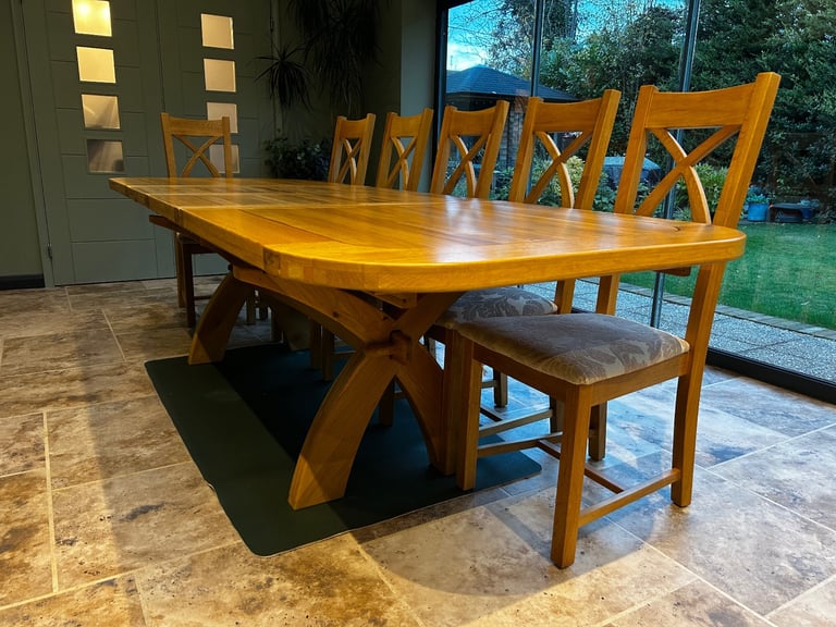 Solid oak dining table and six chairs