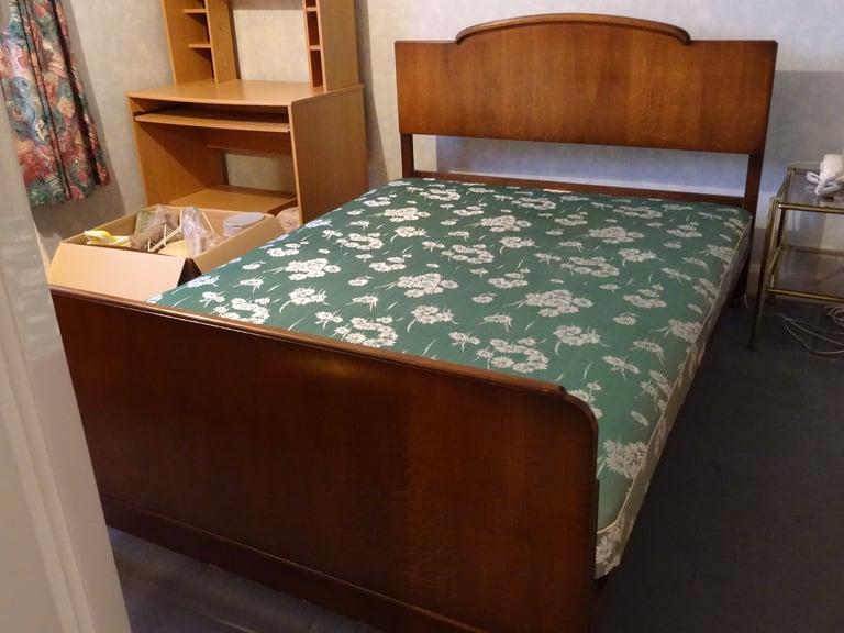 Double bed with fixed wooden headboard and upholstered base