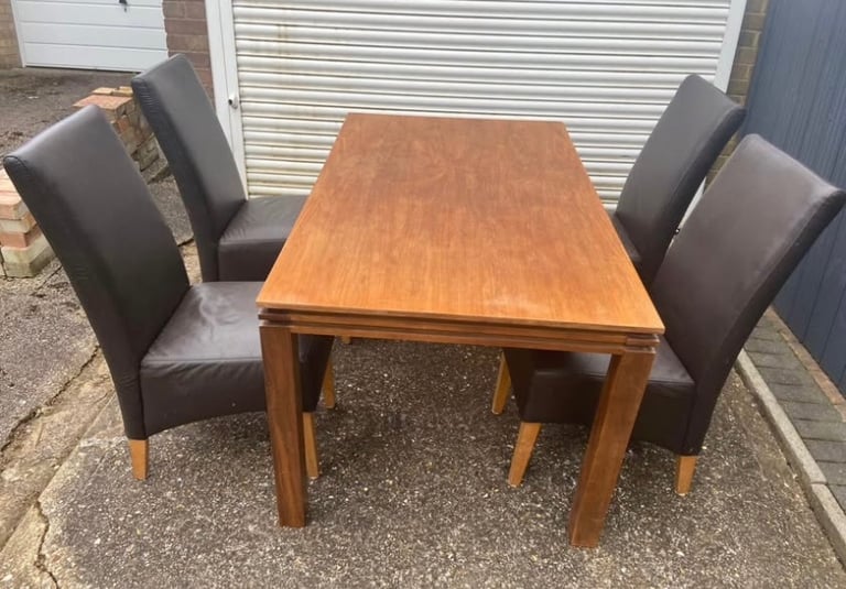 Harvey’s solid pine dining table with 4 leather chairs 