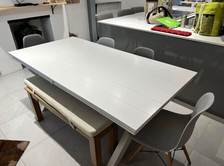 White extendable dining table. Seats up to 10-12