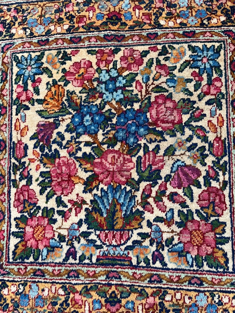 A pair of Antique Kirman mats 
