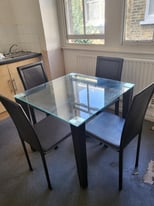 Glass top dinner table with 4 chairs