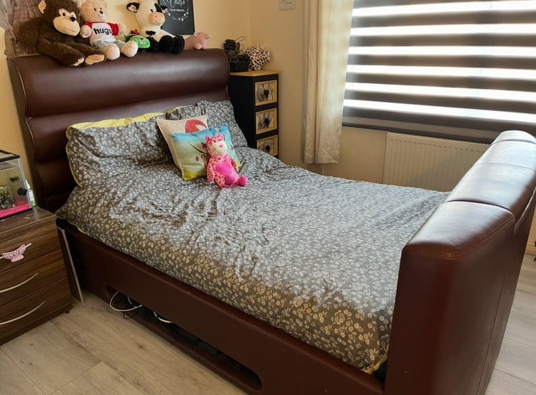 Brown leather double bed under ovening tv lift. 