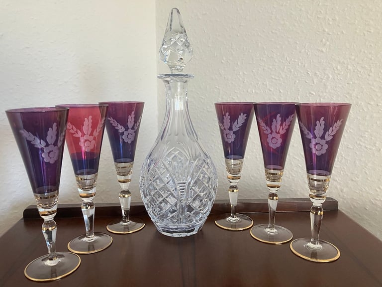 Heavy glass decanter and six vintage wine glasses.
