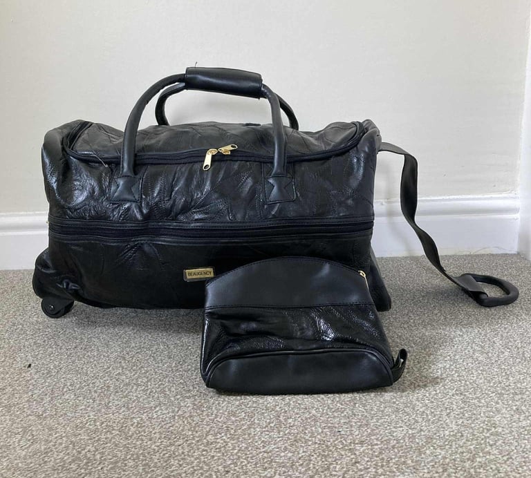 Black 2 wheeled holdall with pull strap + small bag