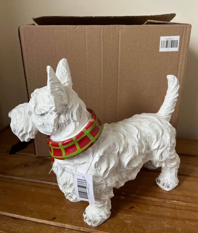 White resin Westie dog ornament wearing a scarf. New in box  Size height 26cm width 31cm depth 14 cm