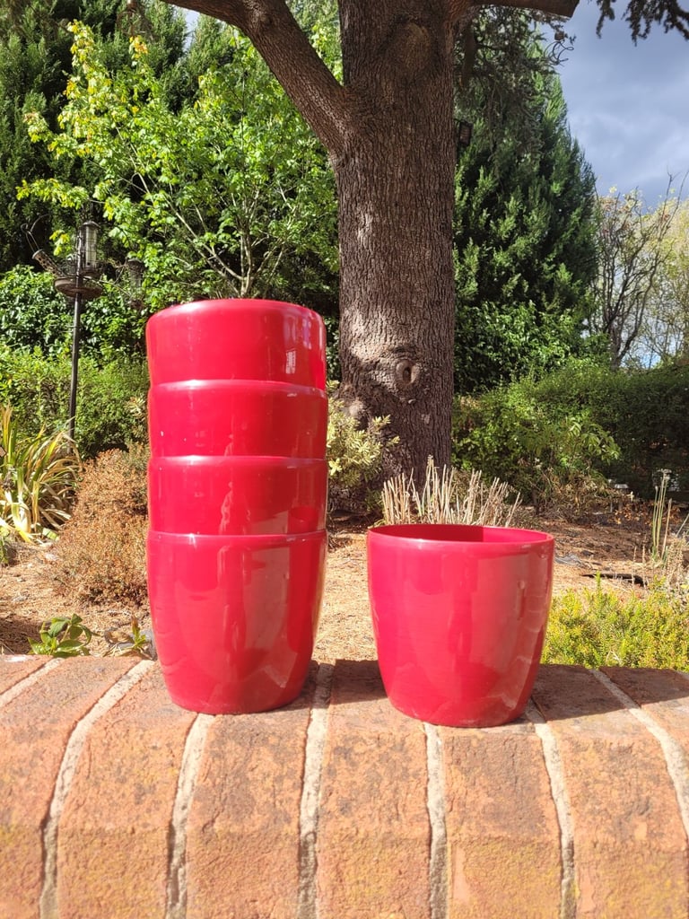 5 mid-sized red pots in good condition