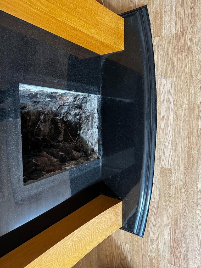 Black marble and wooden fireplace with built in lights