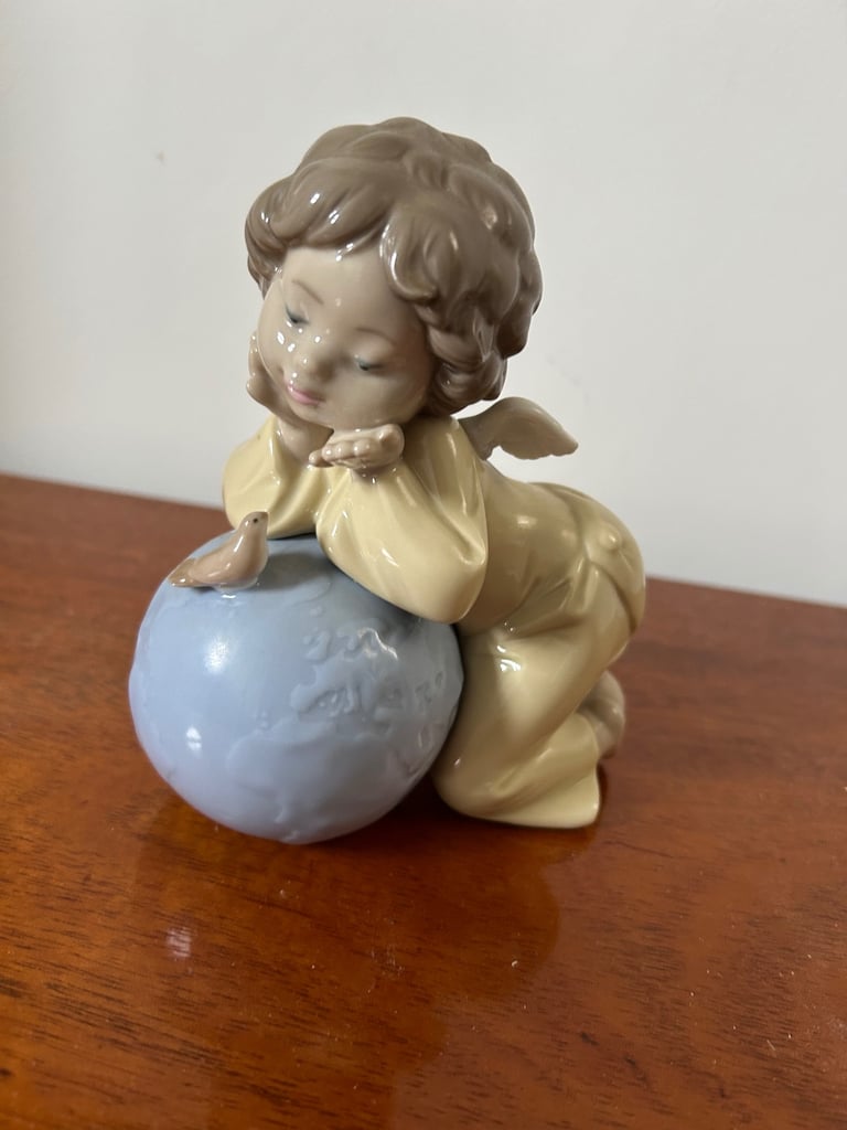 image for NAO by Lladro girl angel, leaning over a globe with bird