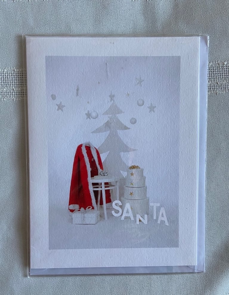 Christmas Card showing Santa’s red coat against white background