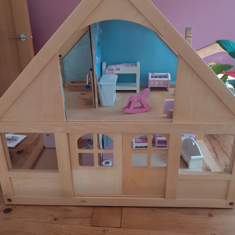 Wooden dolls house with dolls and furniture 