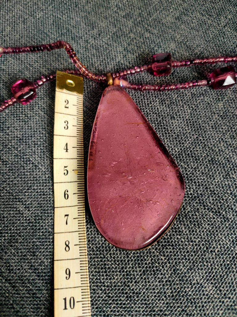 Beautiful glass pendant with glass beads set in metal (possibly copper?).