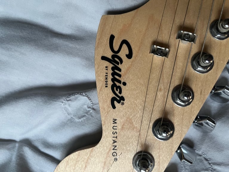 Squier by fender mustang electric guitar in sunburst