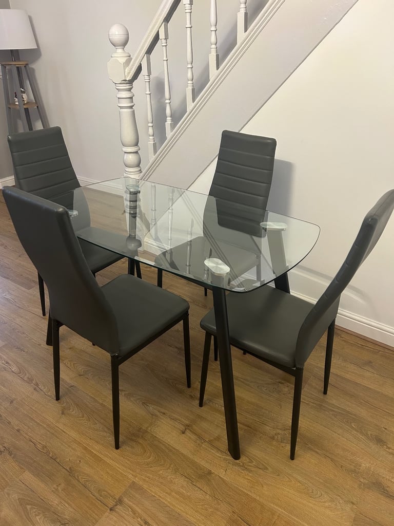 image for Glass dining table & 4 grey faux leather chairs