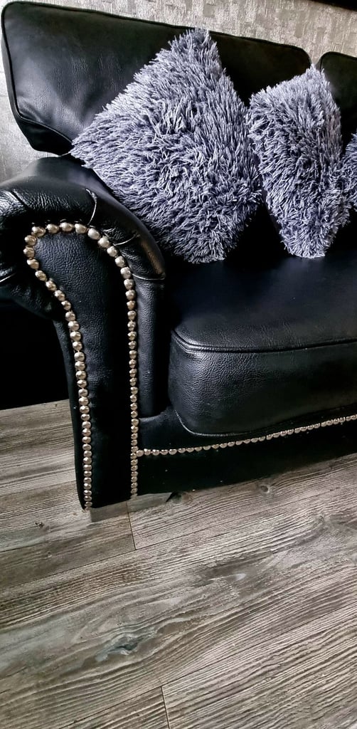 image for Black leather sofa and large foot stool 