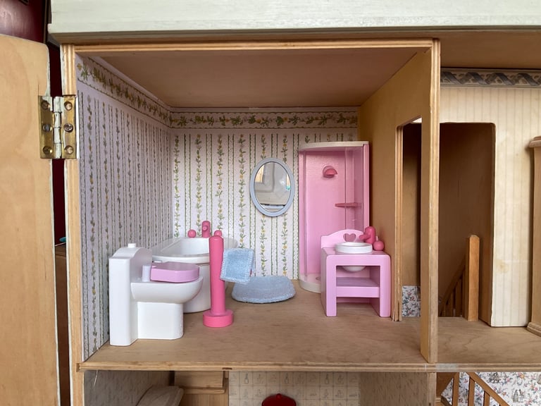 Handmade wooden dolls house with furniture and family