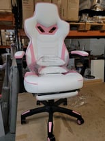 A new stylish white and pink leather effect gaming chair .