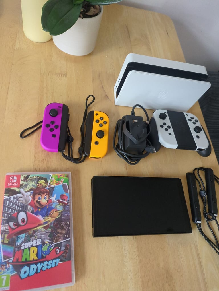 image for Nintendo switch white OLED with extra controllers and Super Mario Odyssey 