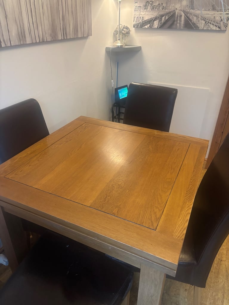 Solid oak extending dining table with chairs and matching mirror