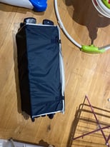 Travel cot on wheels used twice 