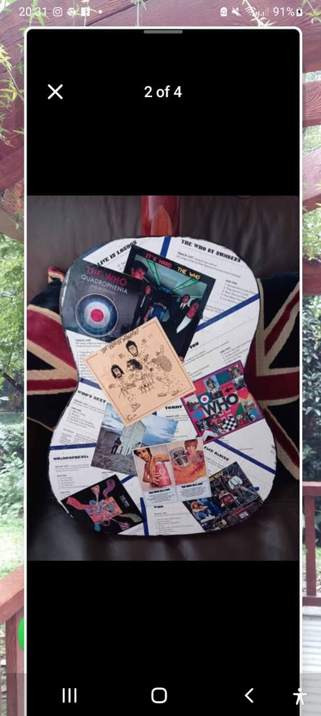 Adult guitar decorated with pictures of the Who, used, still playable 