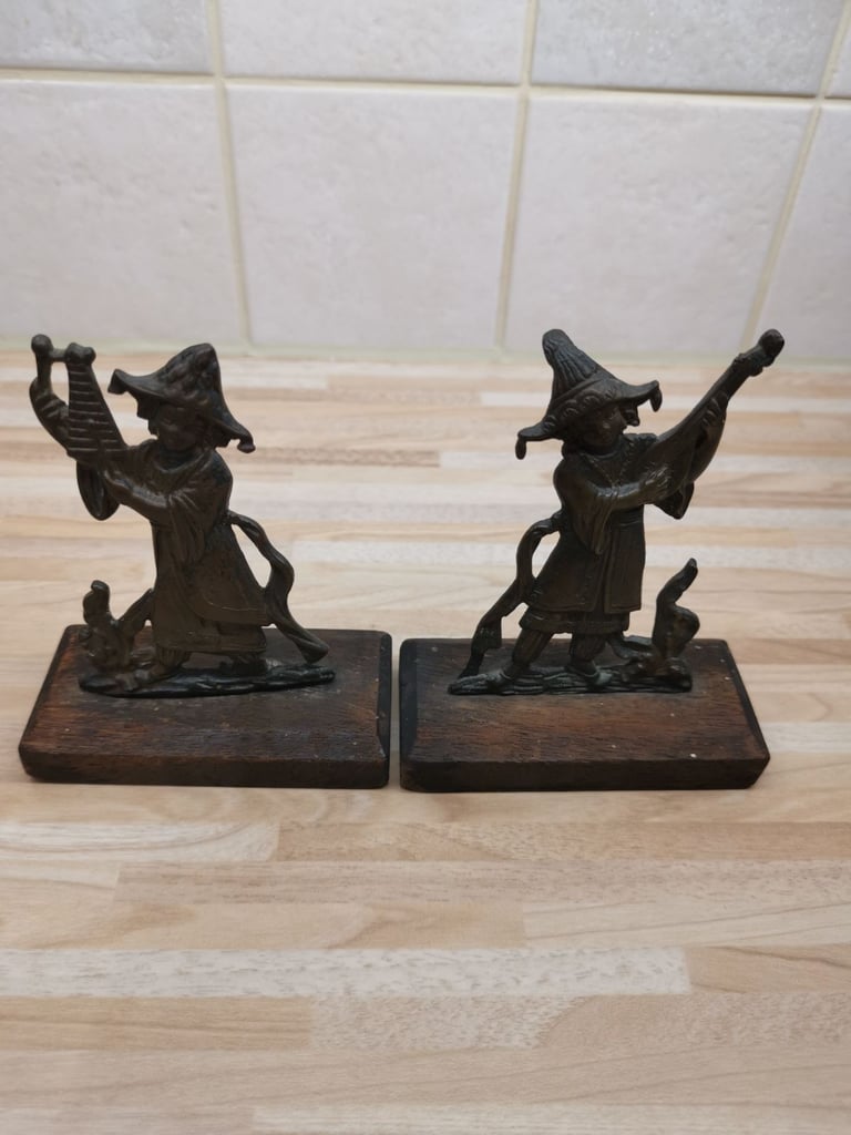 Two mounted bronze 19th Century musician ornaments with a metal plaque