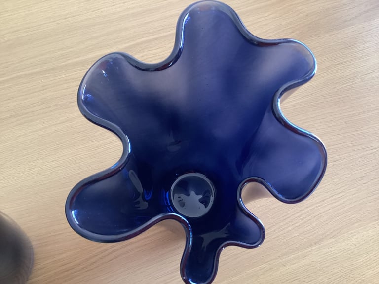 A pair of blue glass flower vases. 