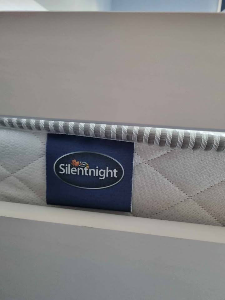 White wooden framed bunk beds with mattresses