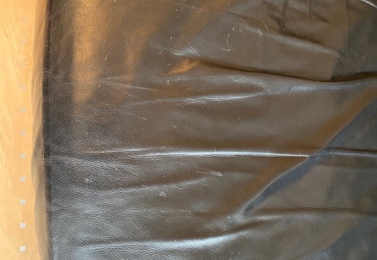 A faux leather sofa in the colour black