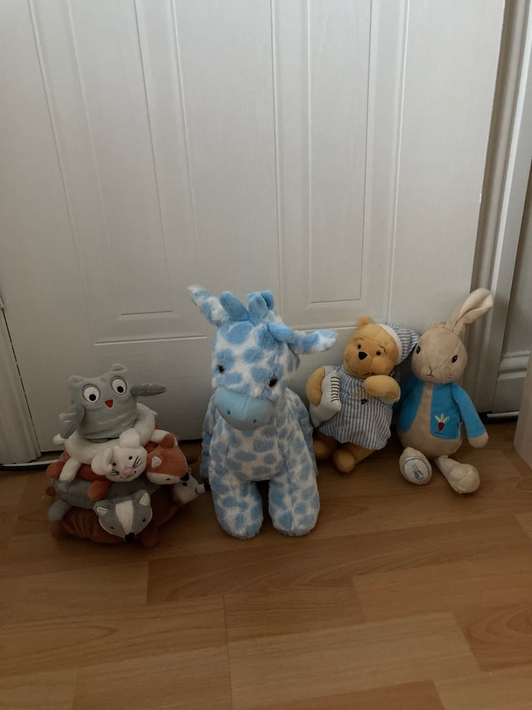 Selection of soft toys inc Peter rabbit bunny, giraffe, Winnie the Pooh and animal stacking ring