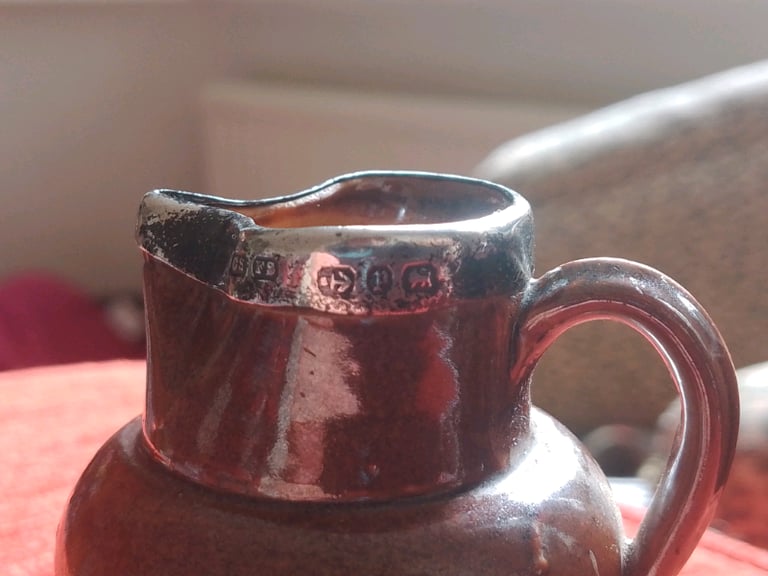 Small antique vintage jug with silver lip