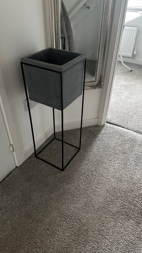 Grey concrete planter with black metal frame
