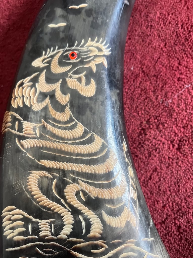 A pair of carved Japanese style horns 