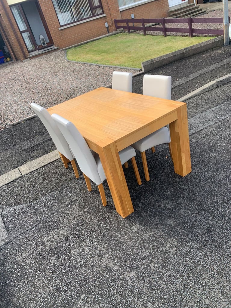 Soild oak table and 4 grey leather chairs 