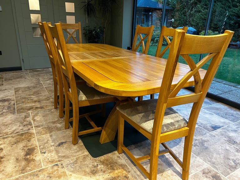 Solid oak dining table and six chairs