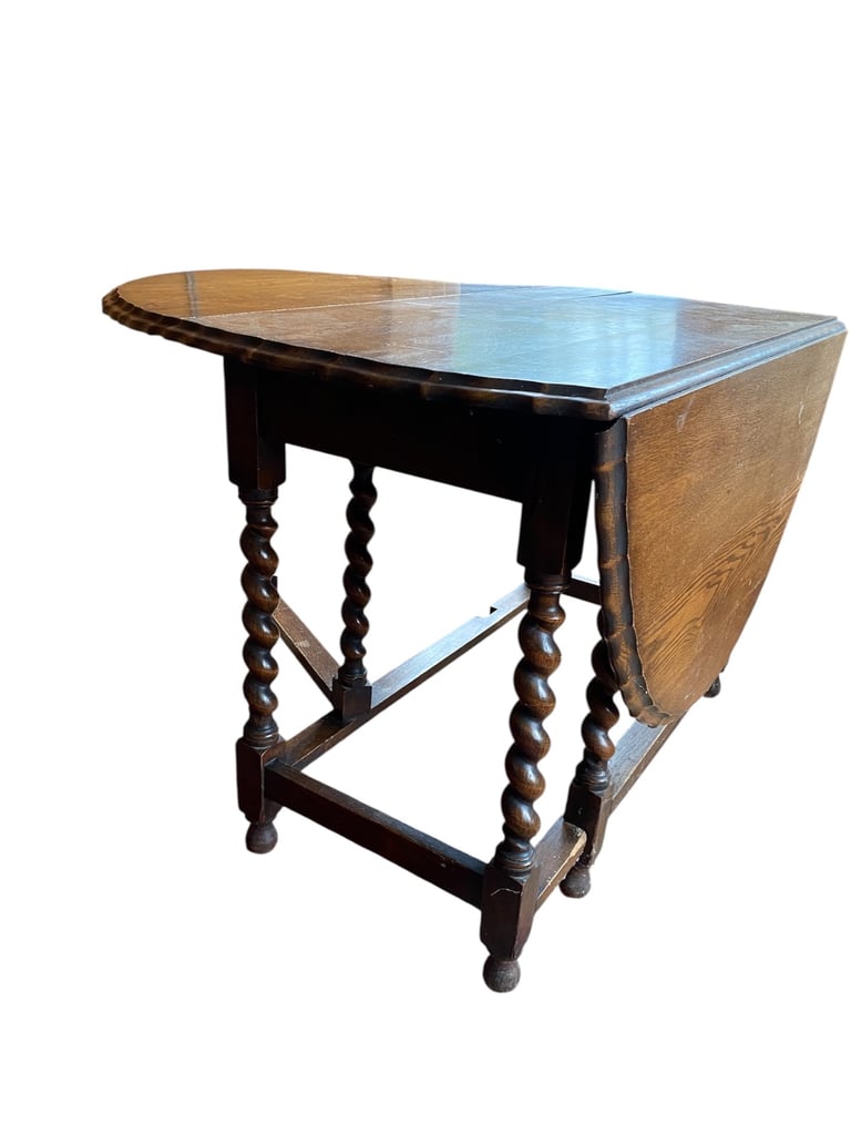 Antique oval pie crust table with barley twist legs and gated.