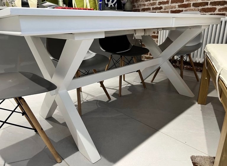 White extendable dining table. Seats up to 10-12