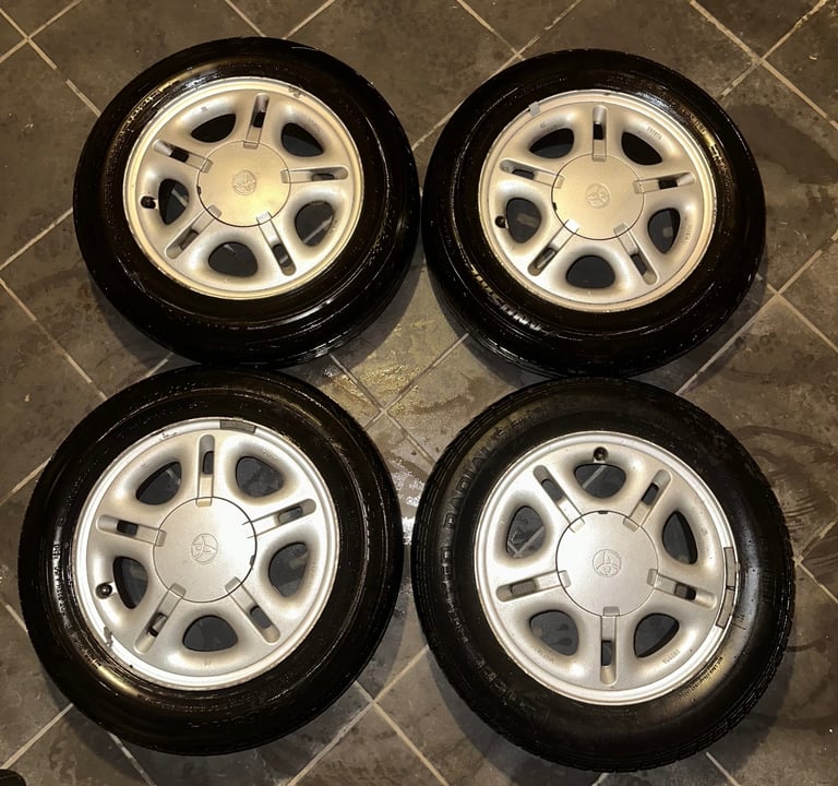 image for Toyota OEM Alloy wheels with centre caps and tyres 4x 100 14x 5.5 JJ