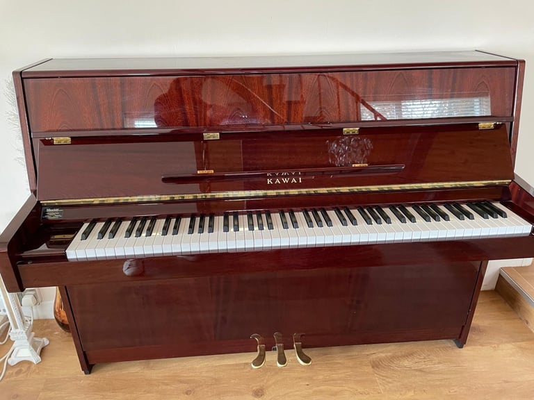 image for Kawai K15E upright piano.  Mahogany with brass fittings and matching stool
