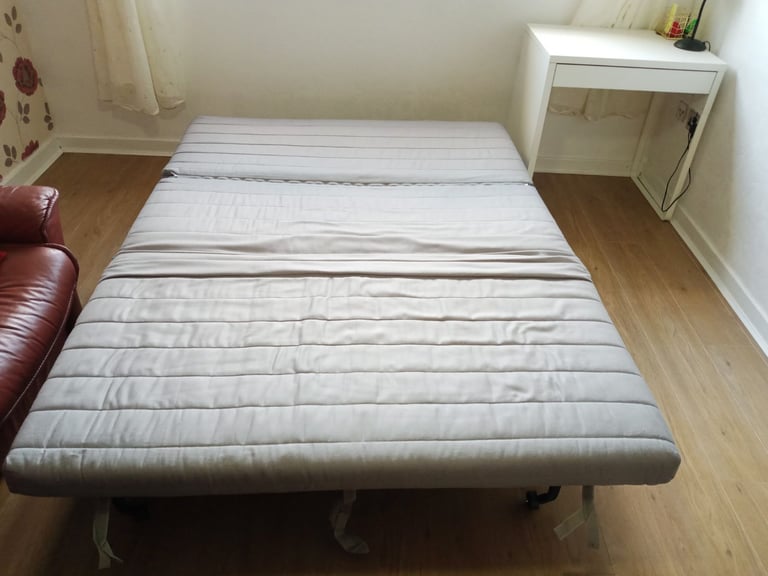 Grey sofa bed with pink cover