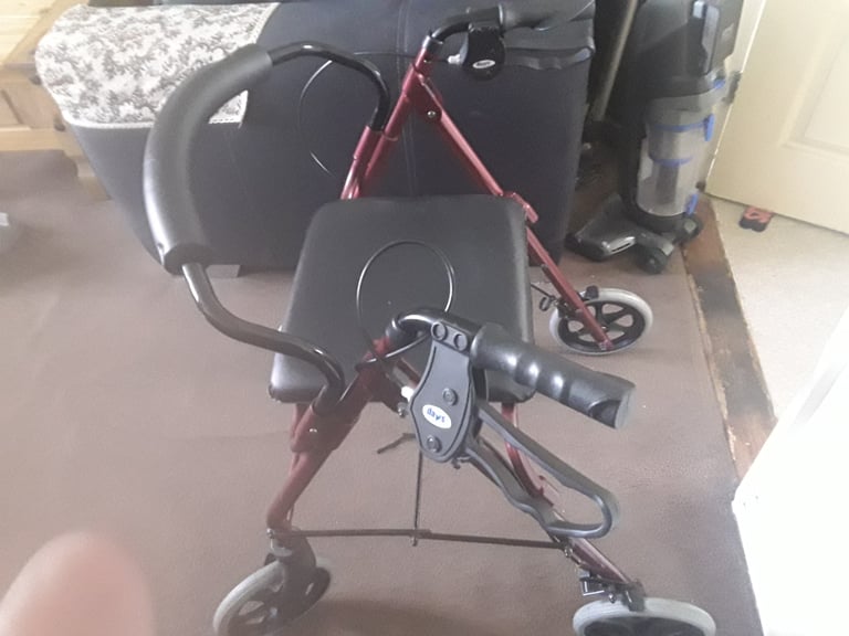 Mobility walker with fold down seat