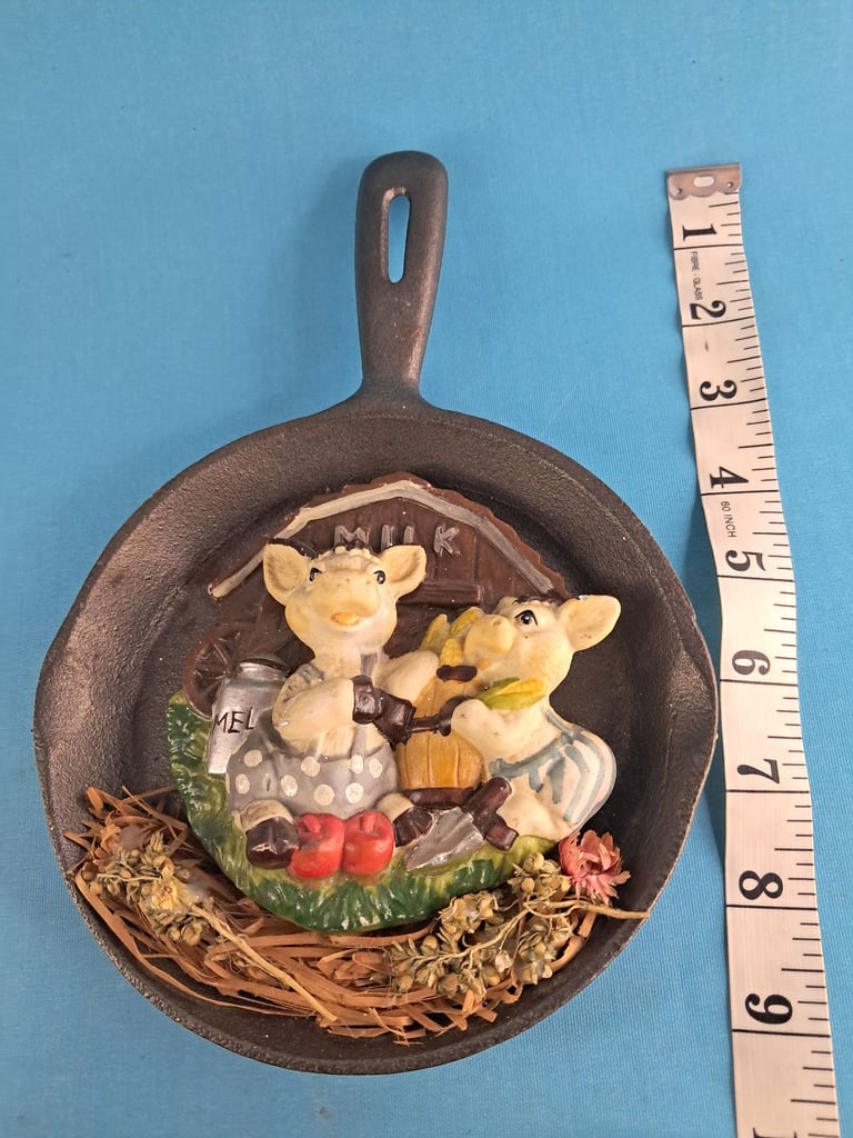image for Vintage decorative cast-iron hanging ornament that features two small pigs. 