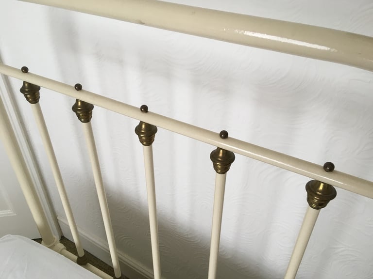 Vintage French brass & cream cast iron single bed on brass & china castors 
