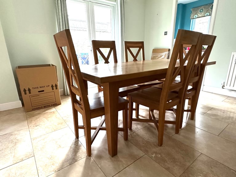 image for Solid oak dining table and six chairs. 