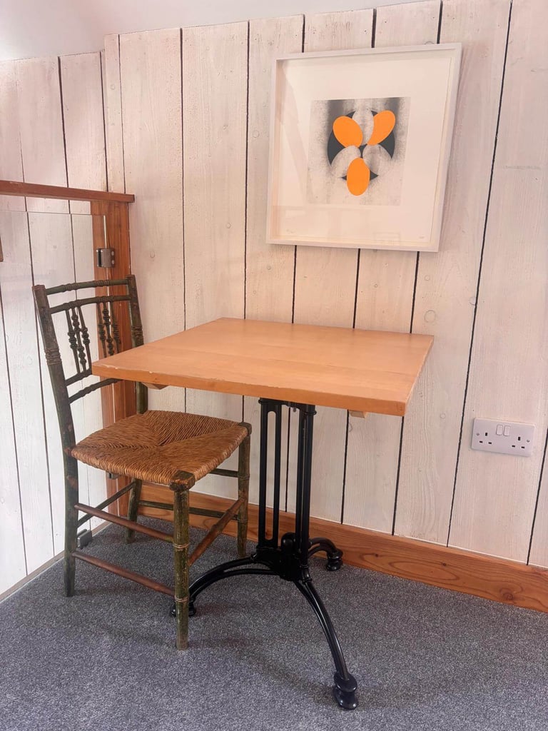 Eleven lovely cafe style tables with wooden tops and vintage style metal bases.
