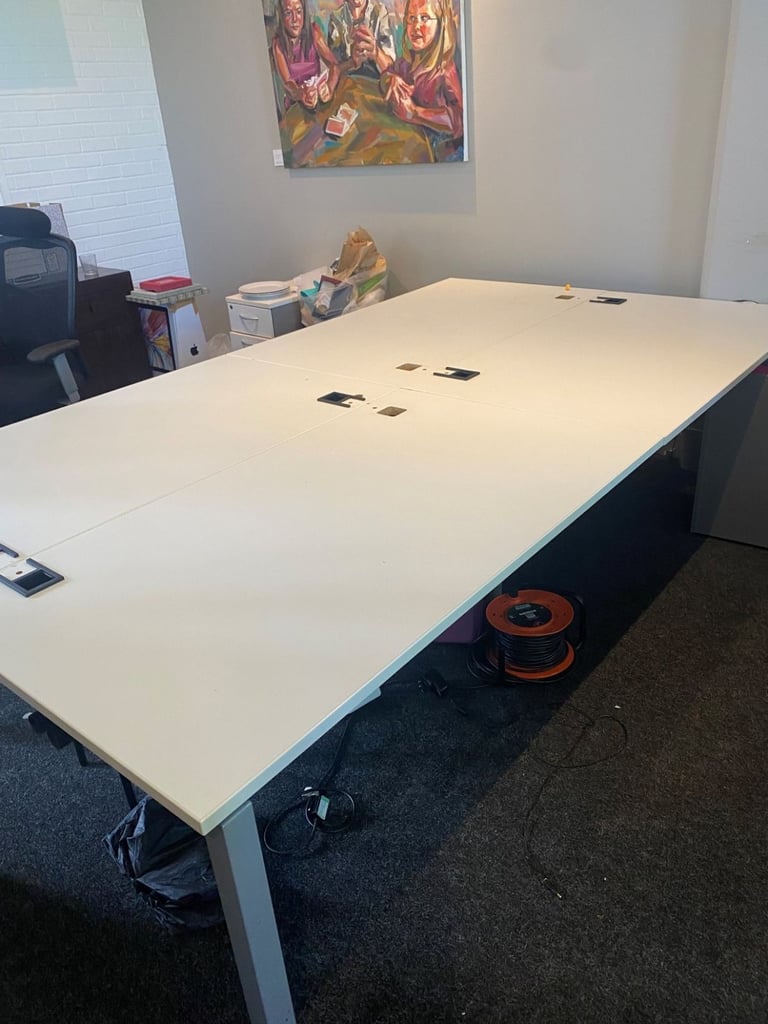 White bank of 4 used office bench desks 1400mm per desk