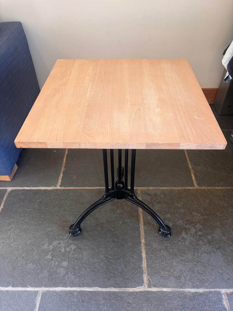 Eleven lovely cafe style tables with wooden tops and vintage style metal bases.