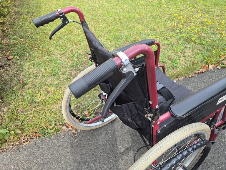 Self propel wheelchair. Brakes on handle. Lap belt. Wheel chair