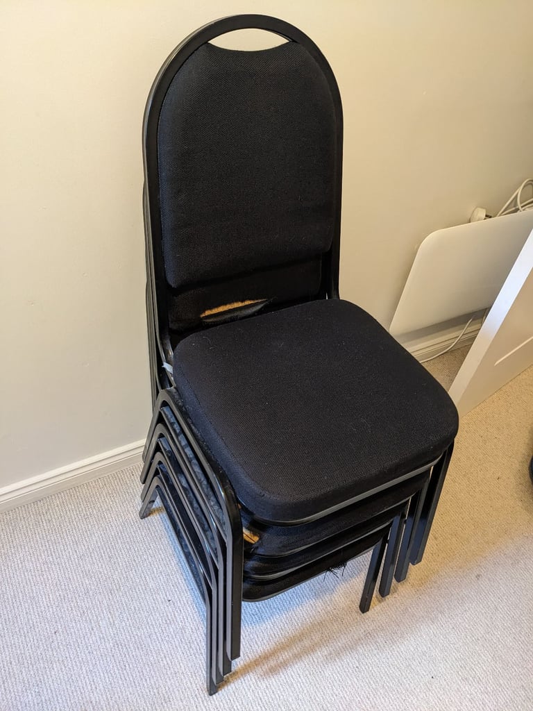 Four black office chairs - stackable 