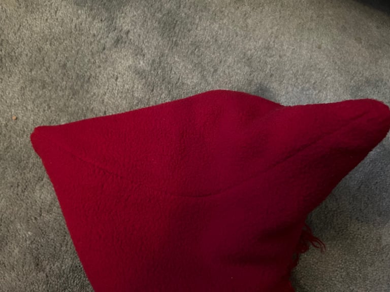 Red fuzzy fleece hat with tassels. .  